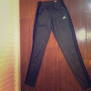 Dark grey Adidas pants.